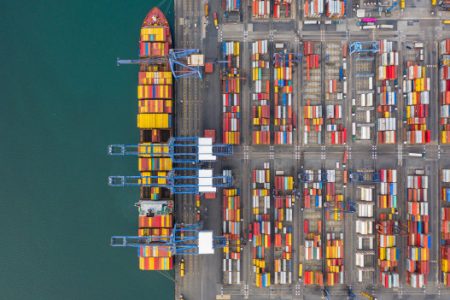 aerial-view-cargo-ship-terminal-unloading-crane-cargo-ship-terminal-aerial-view-industrial-port-with-containers-container-ship_35024-594